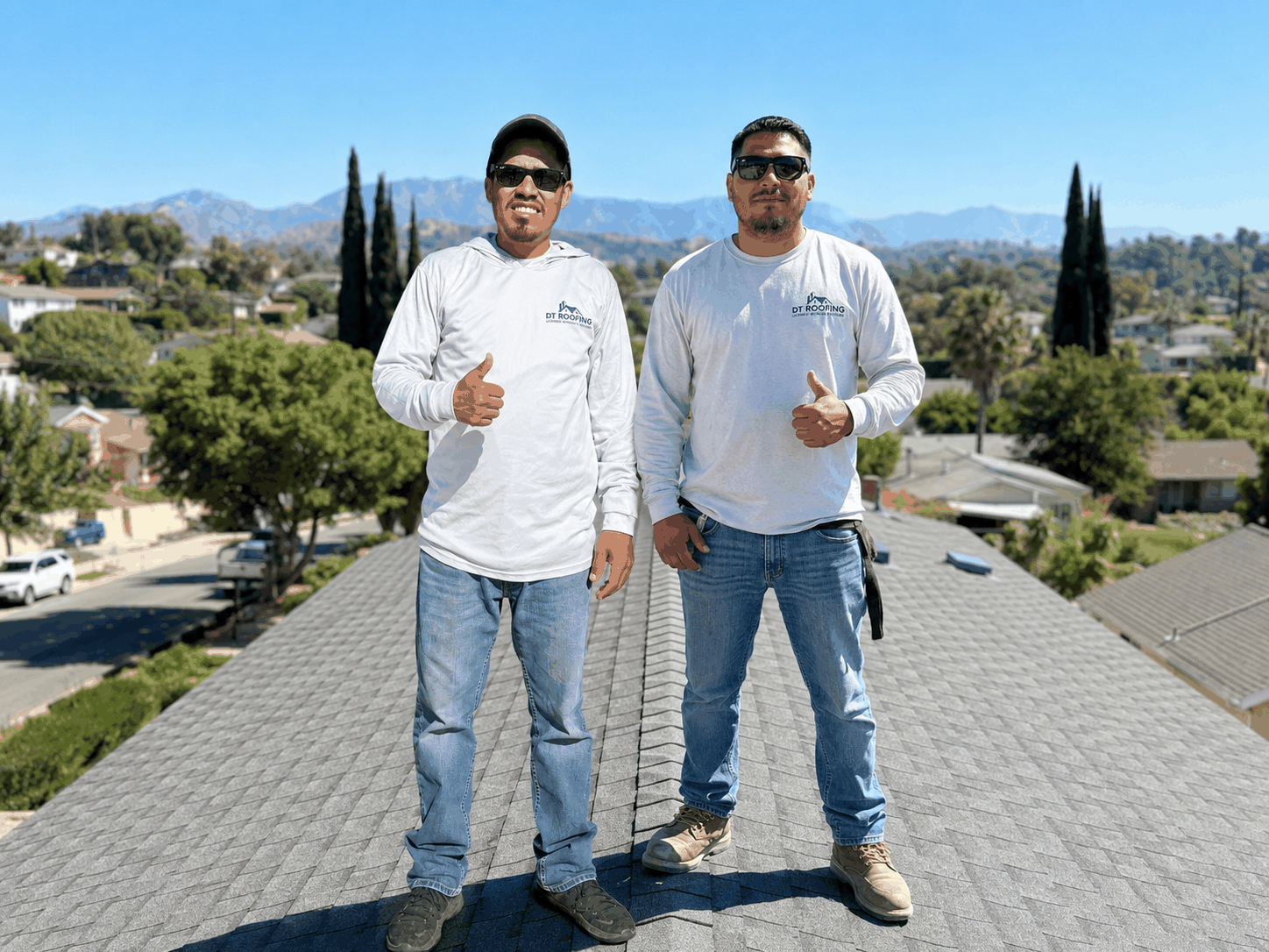 DT Roofing crew installing Spanish tile roof in East Los Angeles at sunset